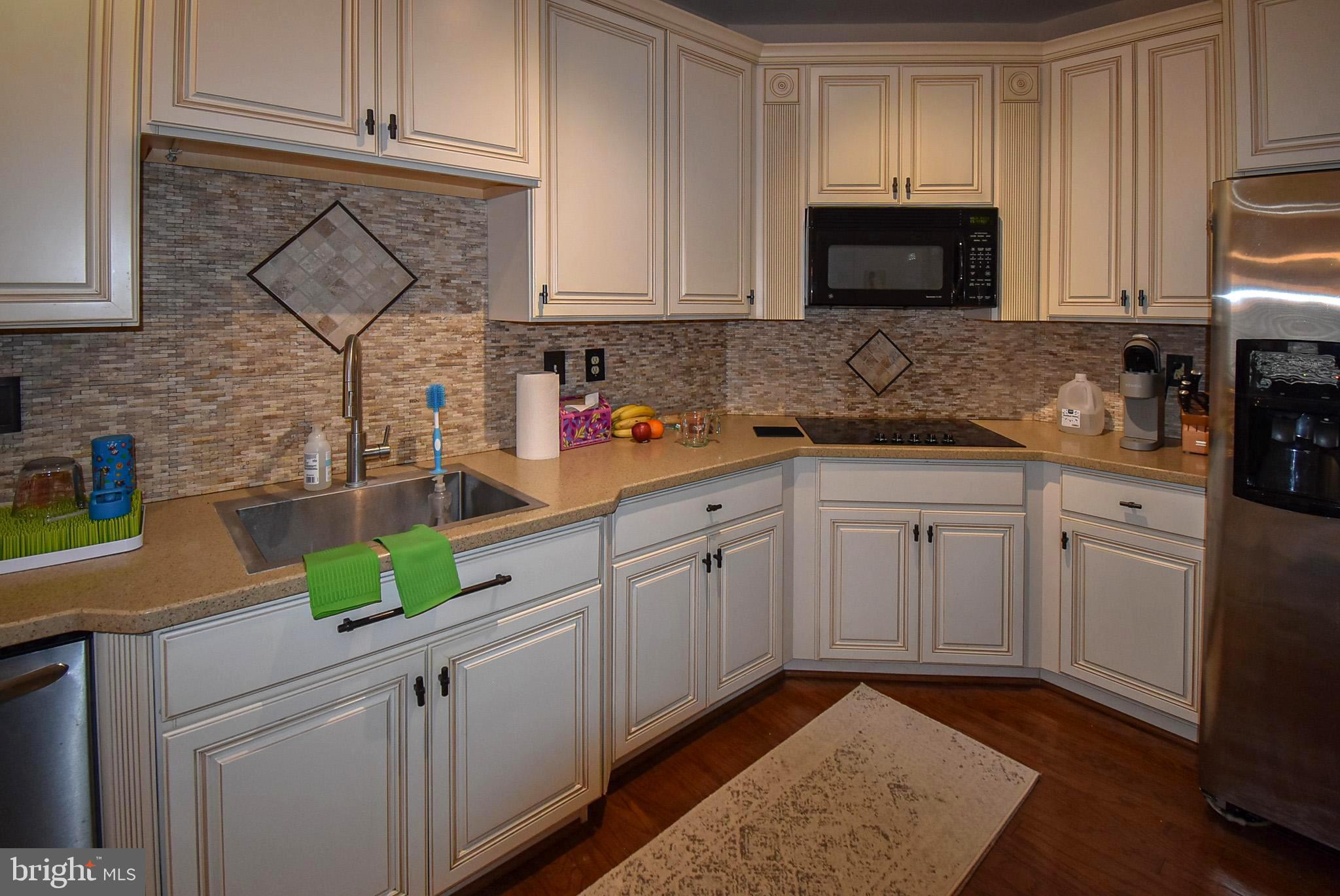 586 Wharton Boulevard Exton, PA 19341 - Photo 7 of 28 a kitchen with stainless steel appliances granite countertop a sink a stove a microwave and cabinets