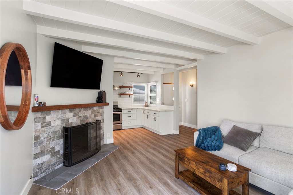 27 66th Place Long Beach, CA 90803 - Photo 11 of 56 a living room with furniture a fireplace and a flat screen tv