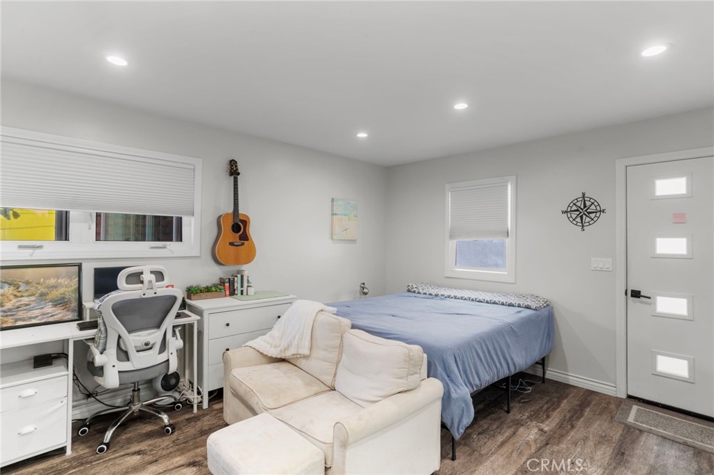 27 66th Place Long Beach, CA 90803 - Photo 18 of 56 a bedroom with a bed a chair and painting on the wall