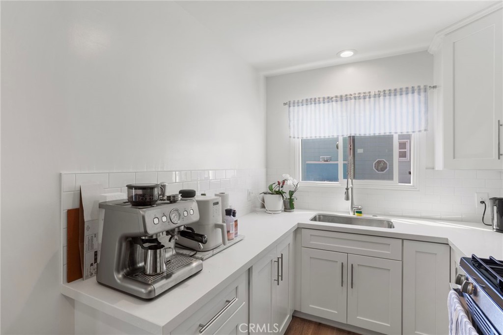 27 66th Place Long Beach, CA 90803 - Photo 29 of 56 a kitchen with sink a stove and cabinets