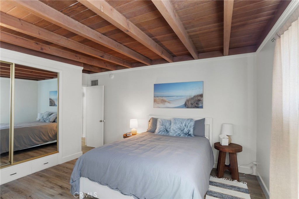27 66th Place Long Beach, CA 90803 - Photo 32 of 56 a bedroom with a bed and wooden floor
