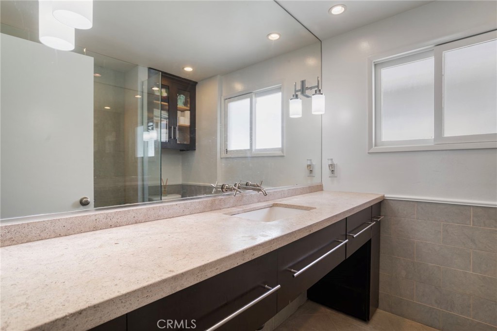 27 66th Place Long Beach, CA 90803 - Photo 37 of 56 a bathroom with a sink and a mirror