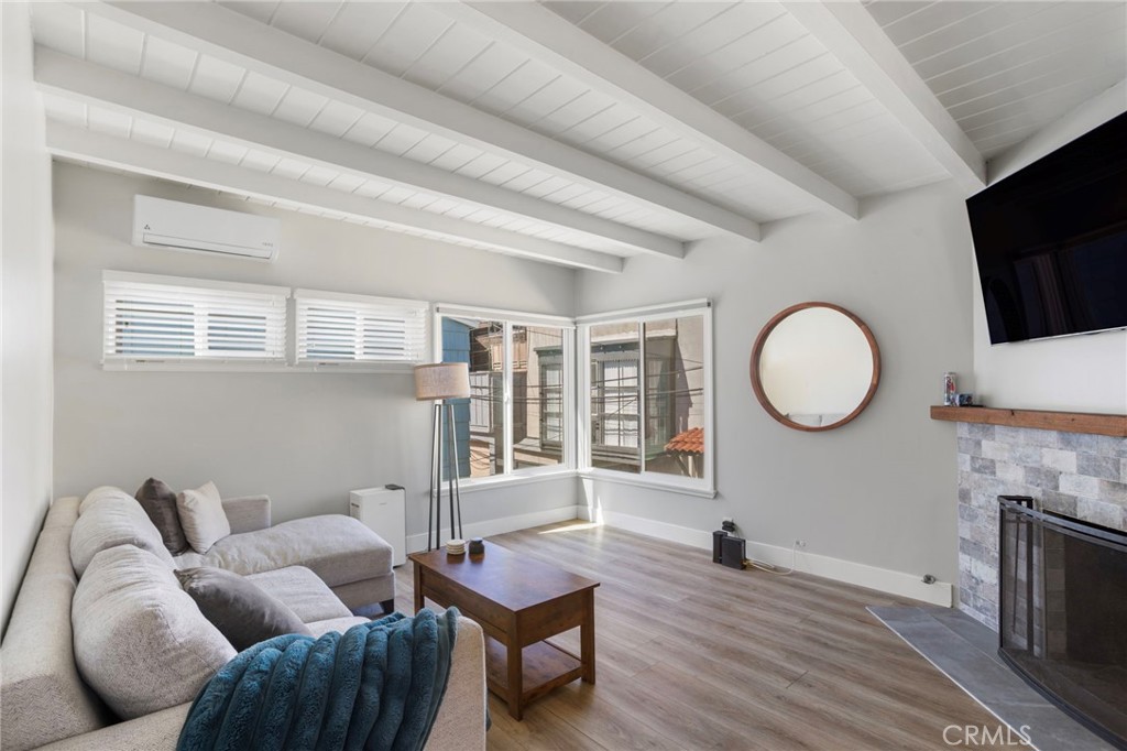 27 66th Place Long Beach, CA 90803 - Photo 9 of 56 a living room with furniture a fireplace and a flat screen tv