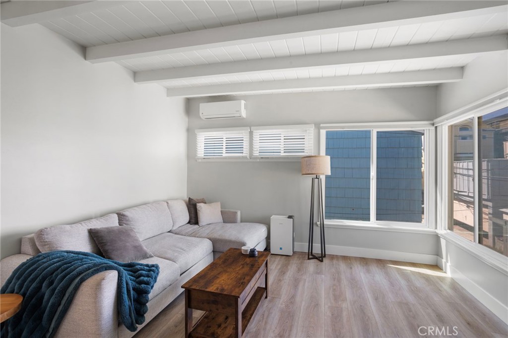 27 66th Place Long Beach, CA 90803 - Photo 10 of 56 a bedroom with a bed and wooden floor