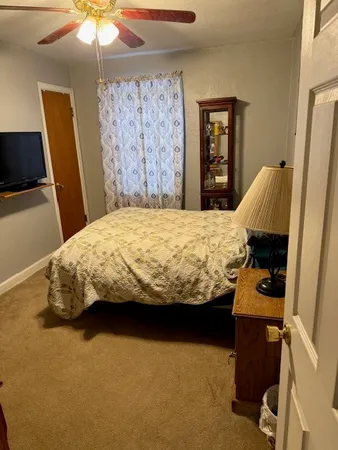 a bedroom with a bed and a chandelier