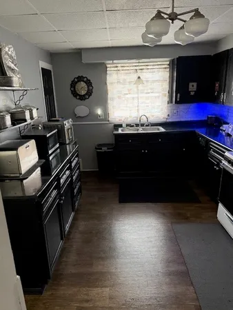 a kitchen with a sink and wooden cabinets