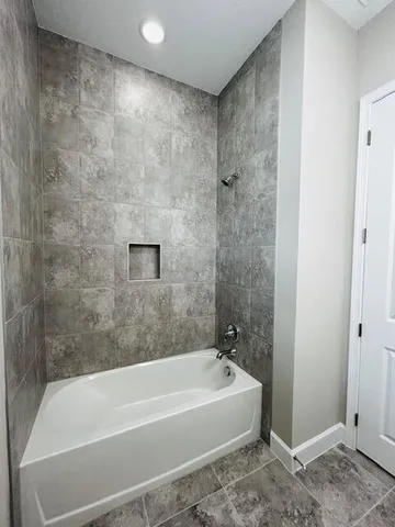a bathroom with a bathtub and a shower