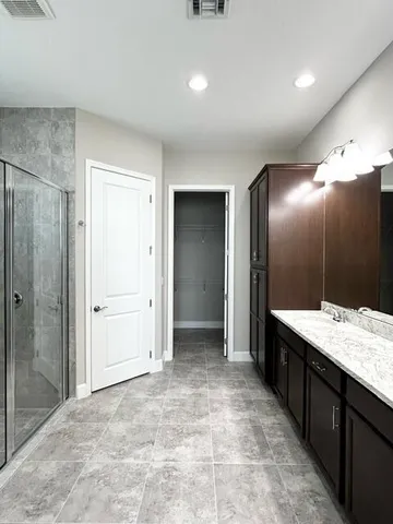 a bathroom with a mirror and a shower