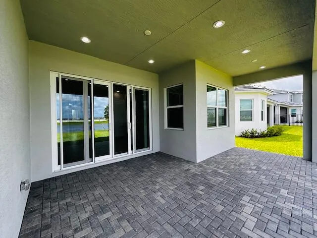 a view of an swimming pool with a porch and yard