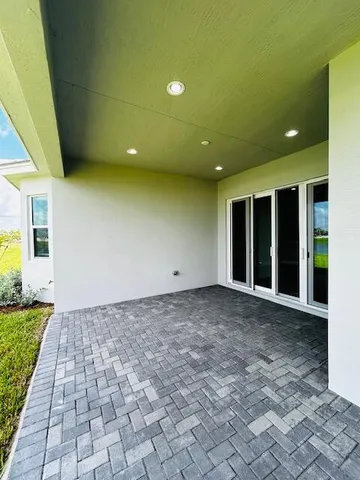 a view of a big room with wooden floor and windows