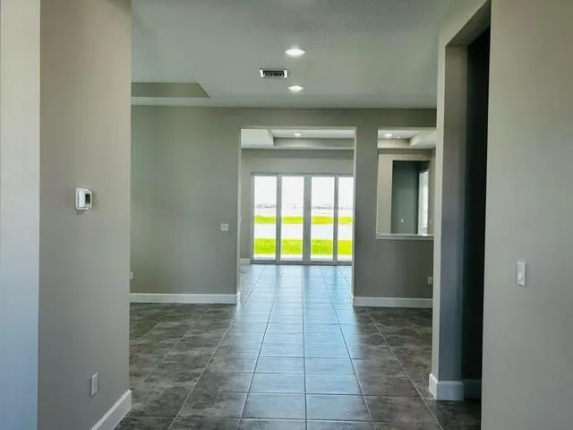 a view of a hallway with wooden floor and a sink