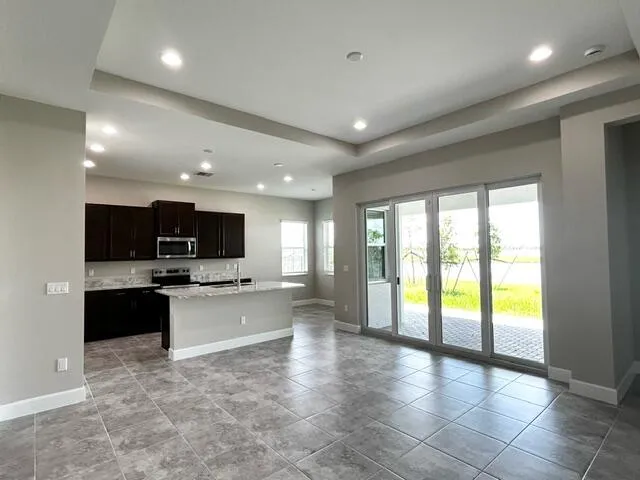 a large kitchen with a large counter top cabinets and stainless steel appliances