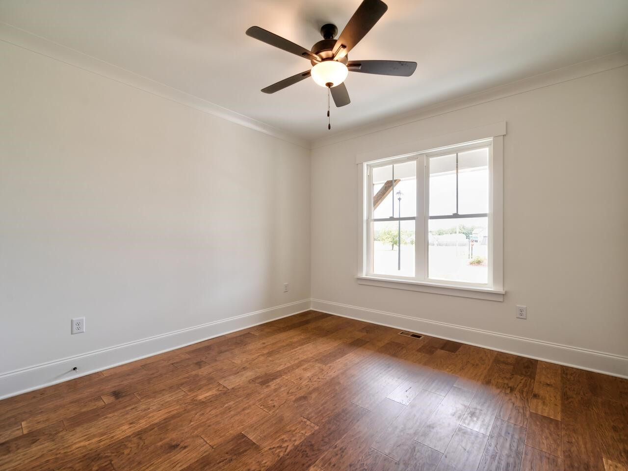 16 Constitution Avenue Smithfield, NC 27577 - Photo 22 of 60 an empty room with wooden floor and windows