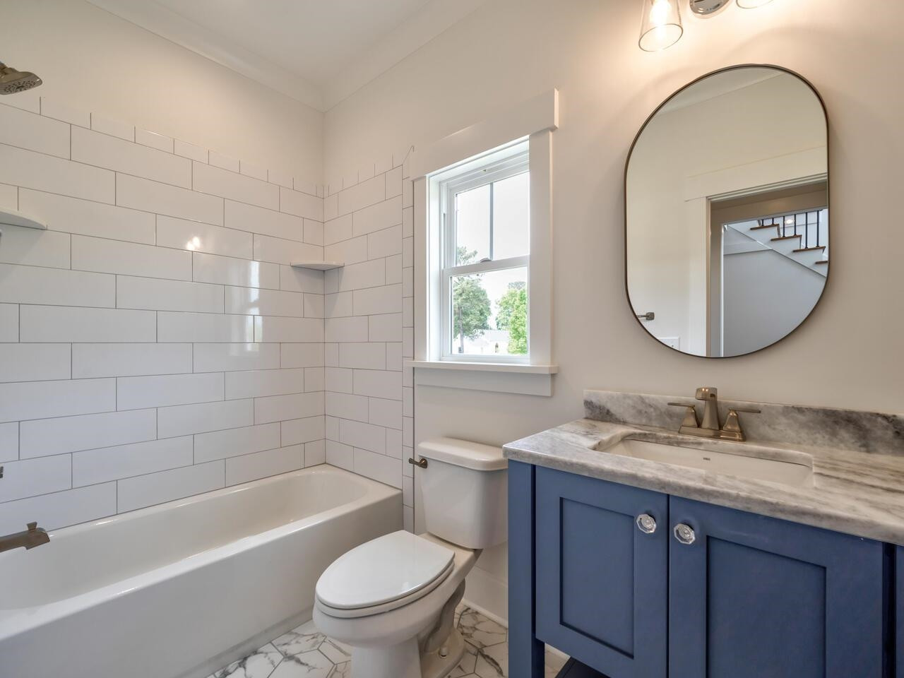 16 Constitution Avenue Smithfield, NC 27577 - Photo 25 of 60 a bathroom with a granite countertop toilet a sink a mirror and bathtub