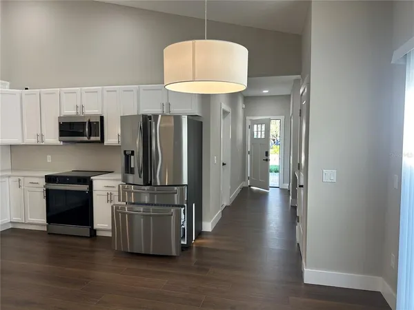 a kitchen with stainless steel appliances a refrigerator and a stove top oven