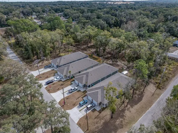 an aerial view of a house with a yard