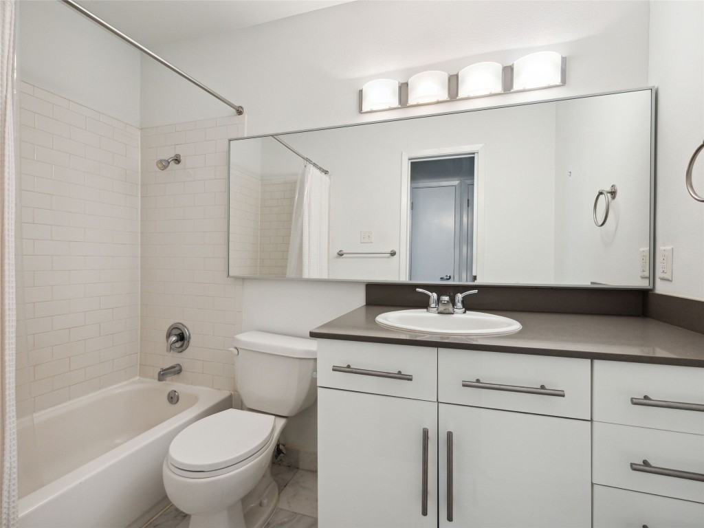 1503 West 9th Street, Unit 204 Austin, TX 78703 - Photo 13 of 21 a bathroom with a granite countertop sink toilet and shower