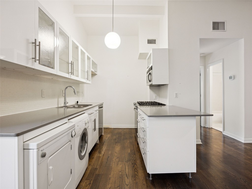 1503 West 9th Street, Unit 204 Austin, TX 78703 - Photo 9 of 21 a kitchen with a sink stove and cabinets