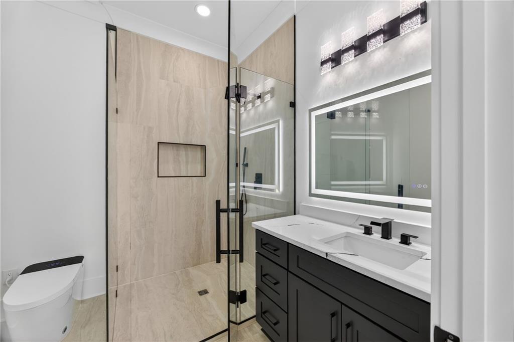 405 Thunder Road Buford, GA 30518 - Photo 80 of 104 a bathroom with a granite countertop sink mirror and a shower