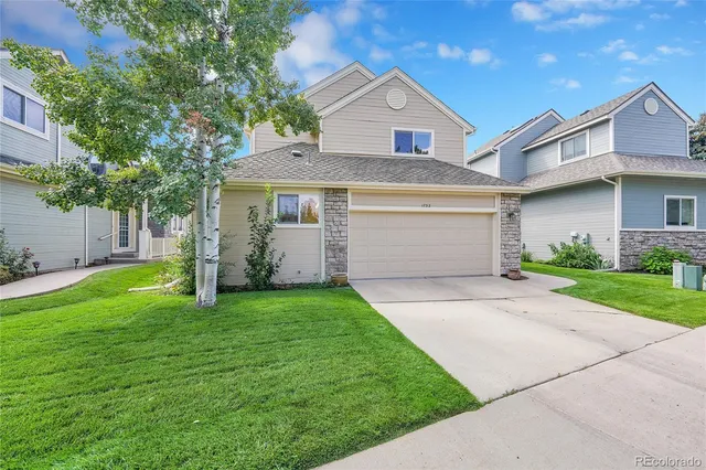 a view of a brick house with potted plants