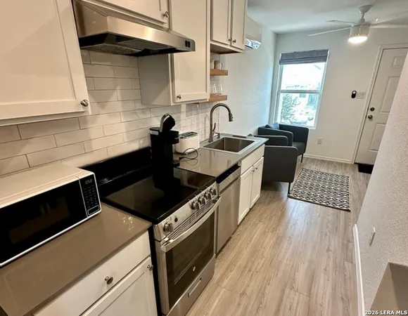 a kitchen with wooden cabinets and a stove top oven