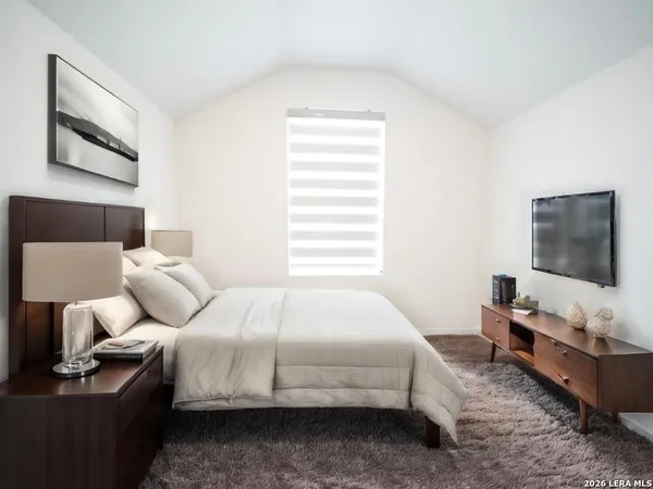 a bedroom with bed and a flat screen tv