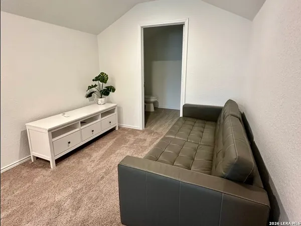 a living room with furniture and flowers