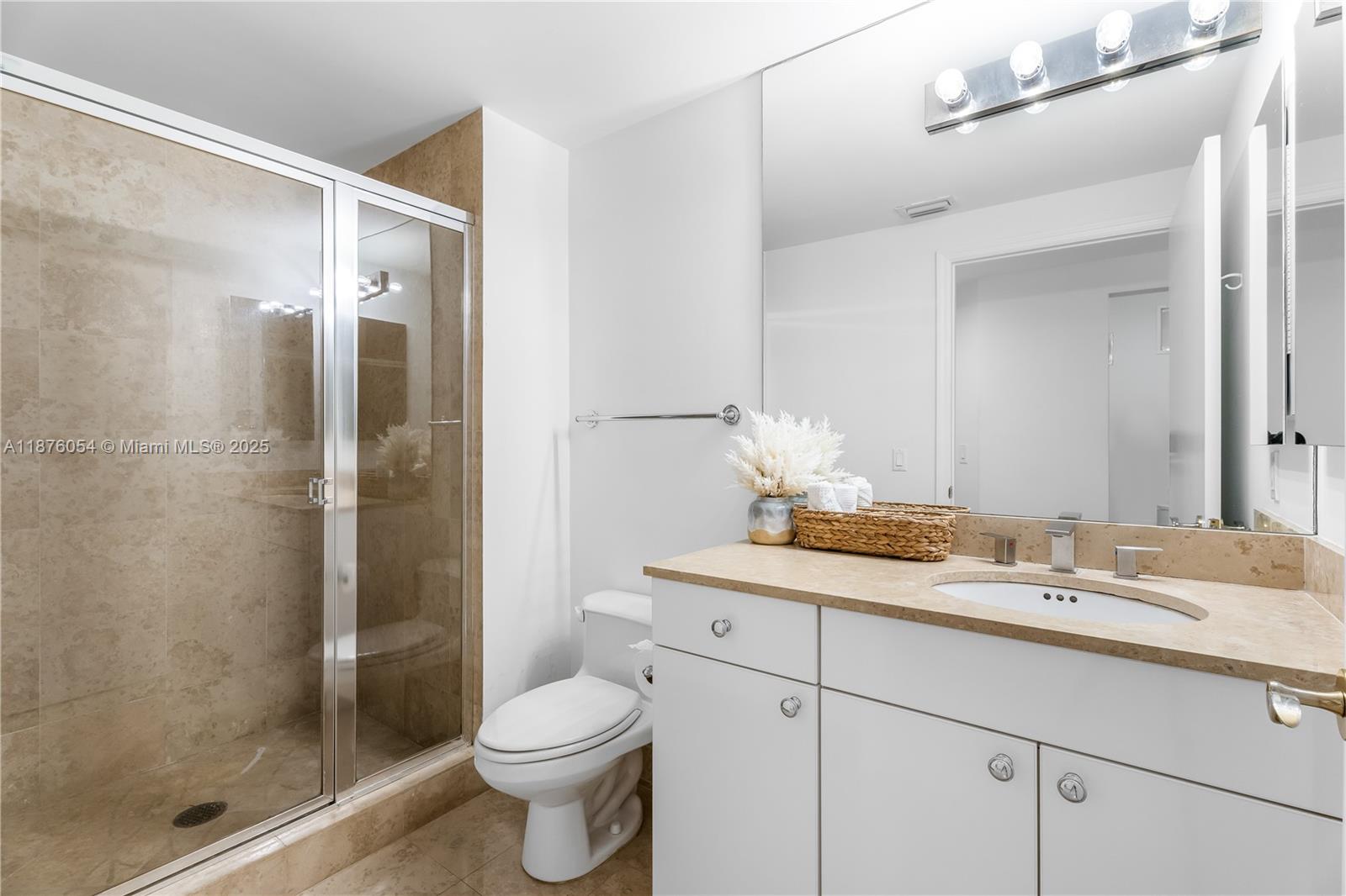 4779 Collins Avenue, Unit 1008 Miami Beach, FL 33140 - Photo 11 of 36 a bathroom with a sink and a mirror