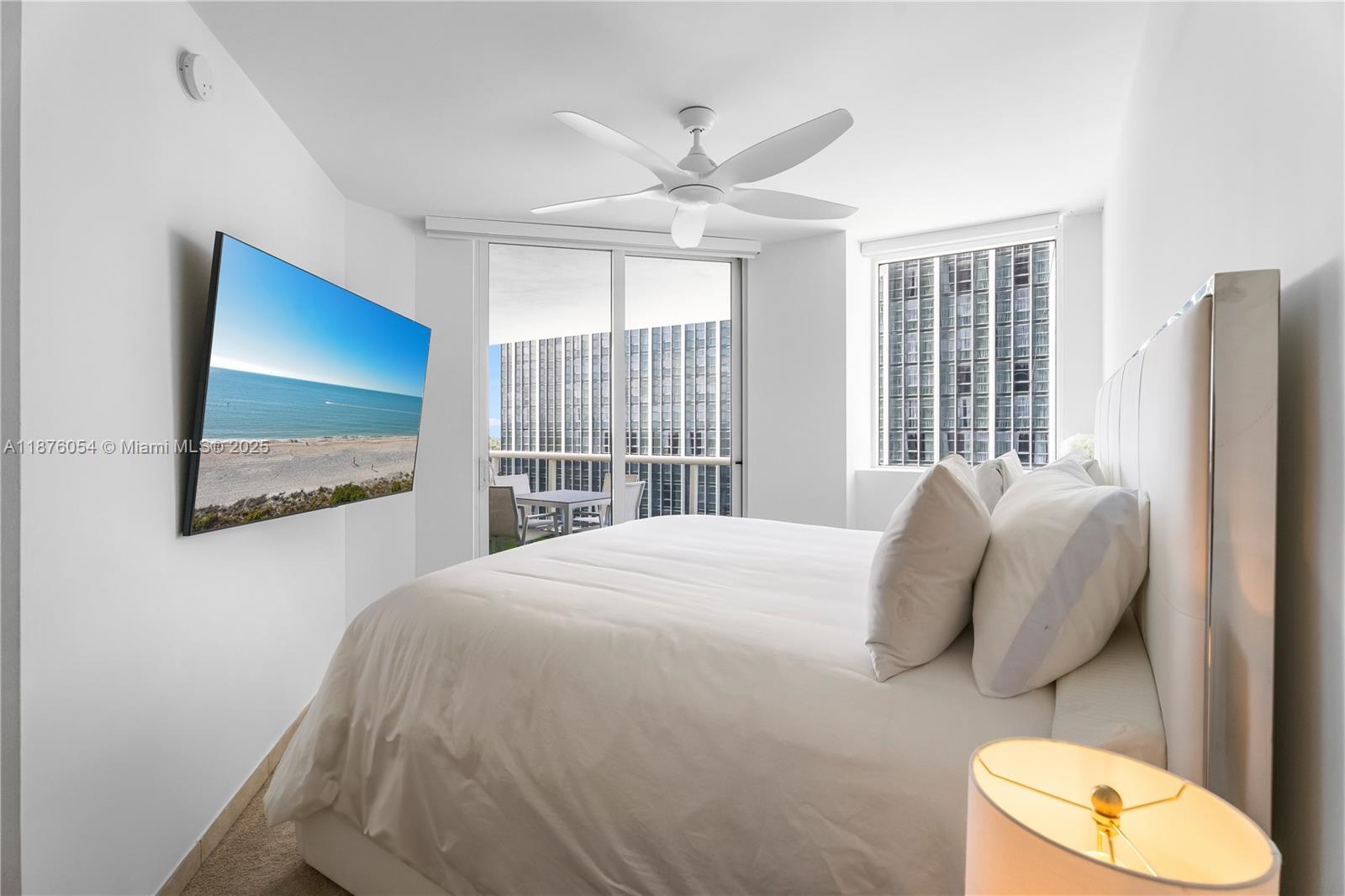 4779 Collins Avenue, Unit 1008 Miami Beach, FL 33140 - Photo 12 of 36 a bedroom with a bed and a large window