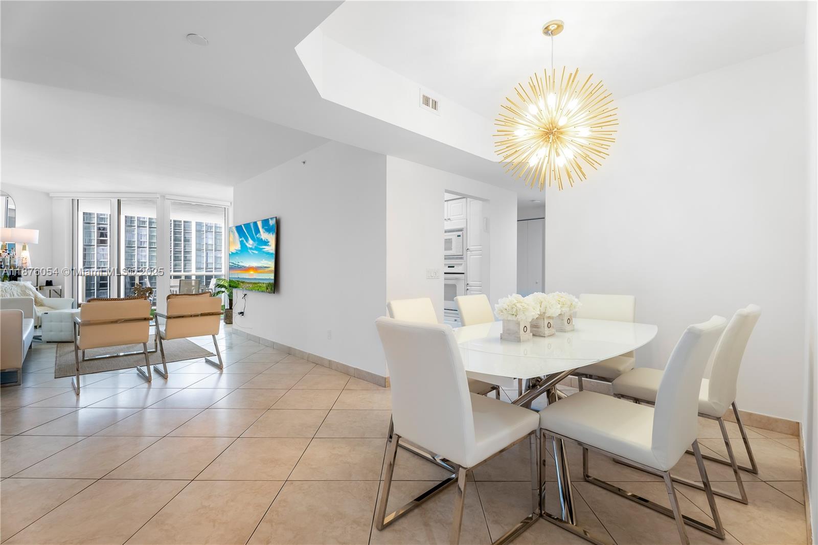 4779 Collins Avenue, Unit 1008 Miami Beach, FL 33140 - Photo 13 of 36 a view of a dining room with furniture and a potted plant