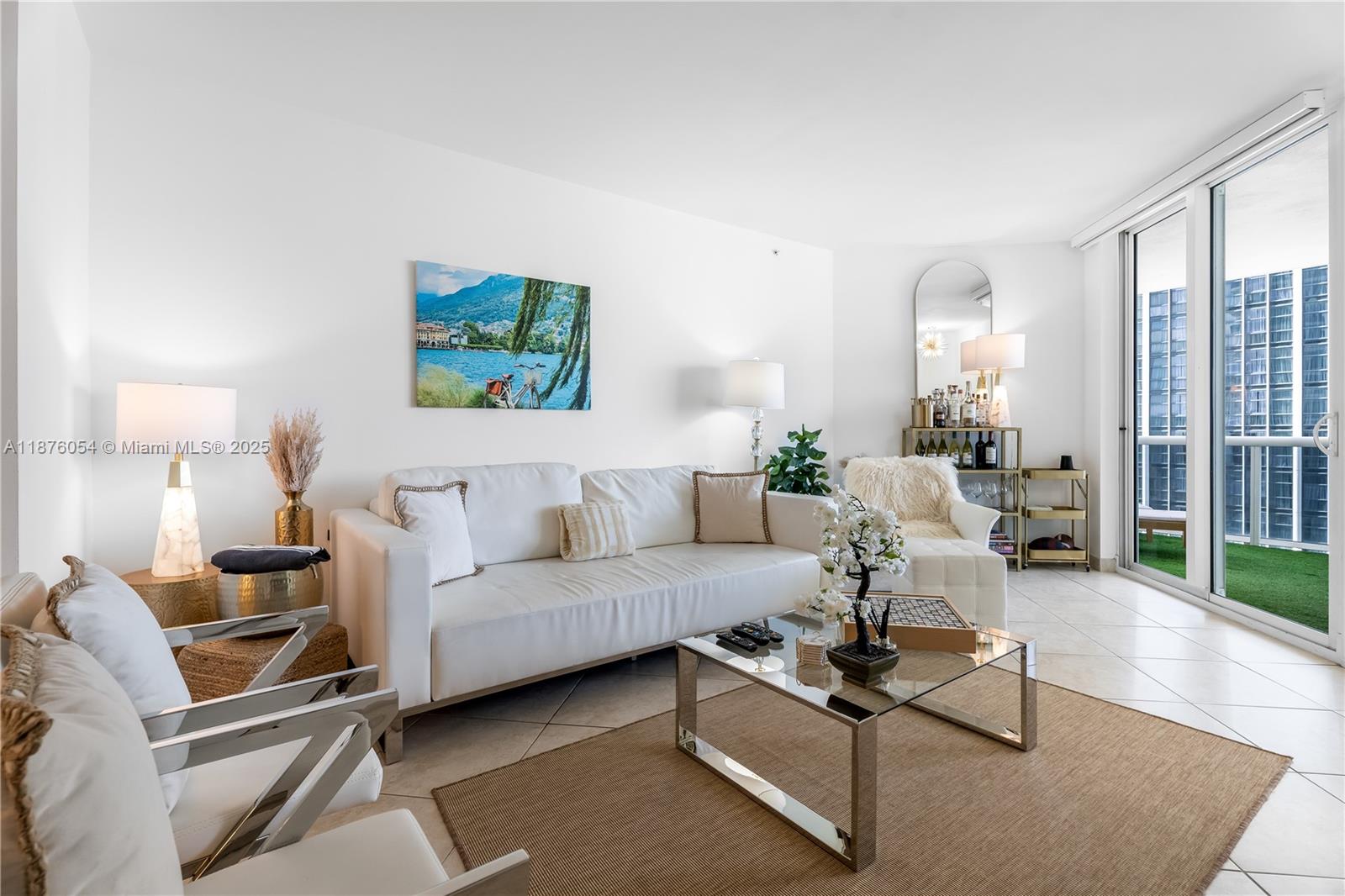 4779 Collins Avenue, Unit 1008 Miami Beach, FL 33140 - Photo 15 of 36 a living room with furniture a rug and a large window