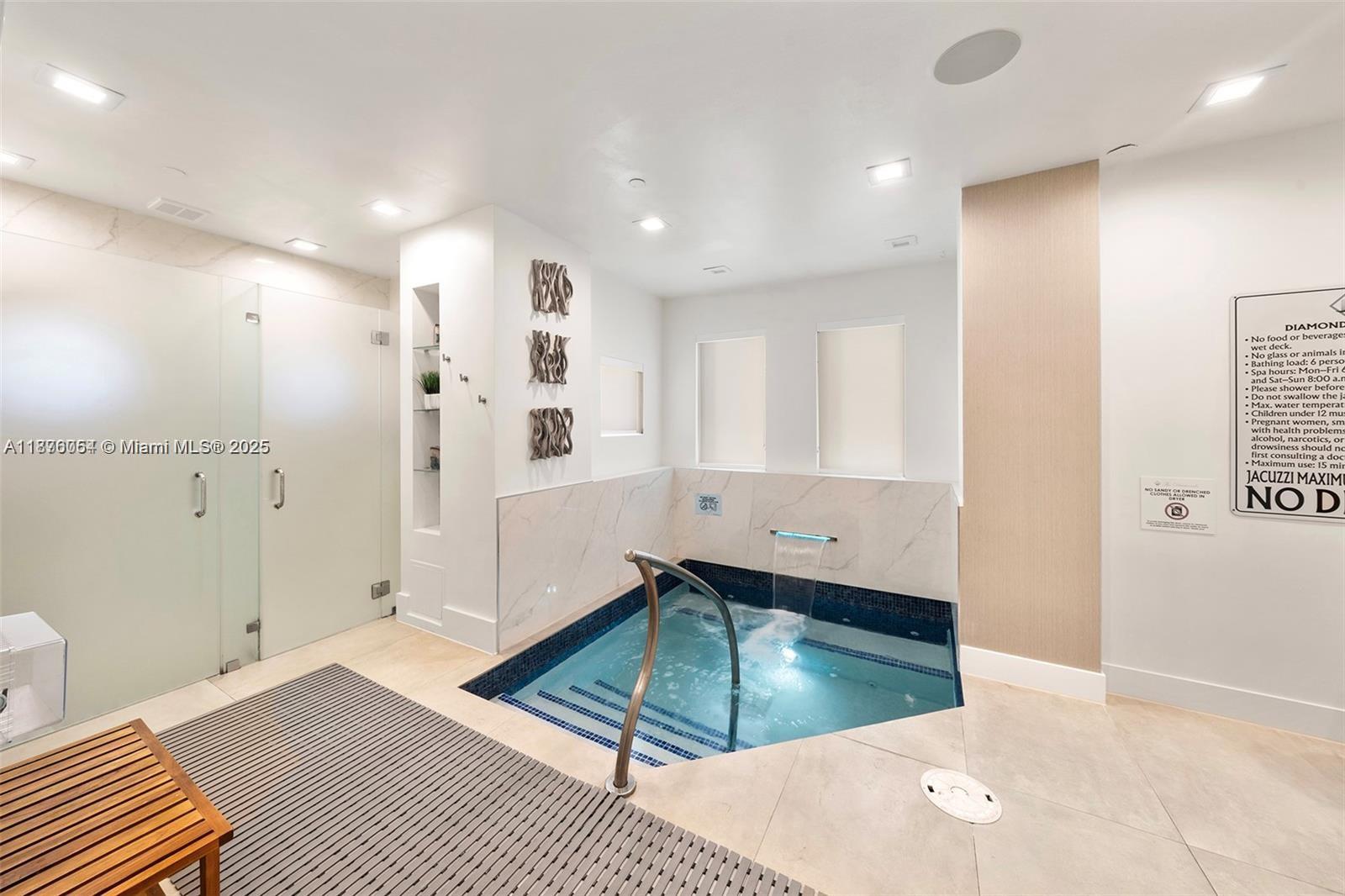 4779 Collins Avenue, Unit 1008 Miami Beach, FL 33140 - Photo 19 of 36 a bathroom with a tub and a shower