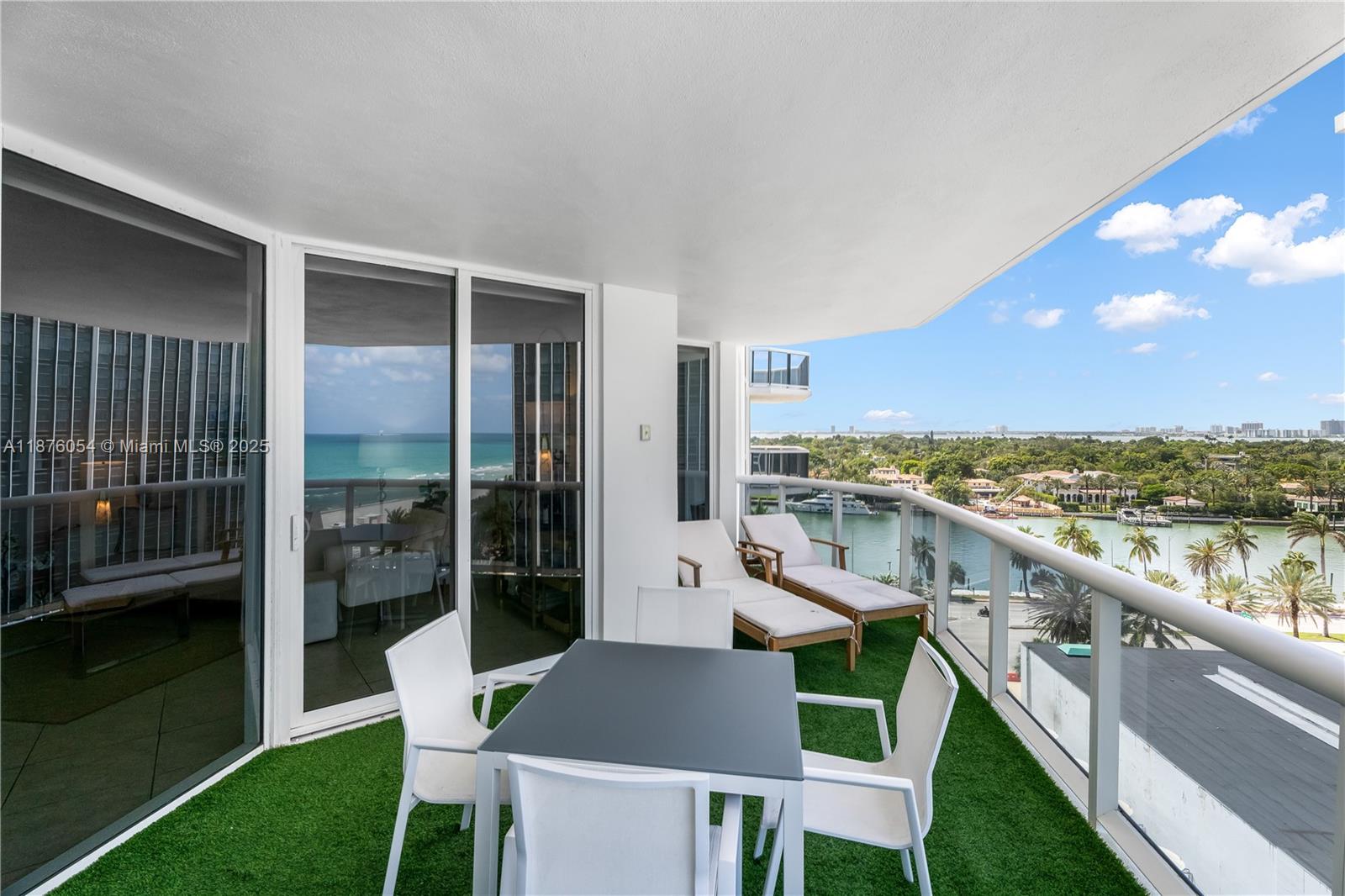 4779 Collins Avenue, Unit 1008 Miami Beach, FL 33140 - Photo 2 of 36 a view of a balcony with a table and chairs