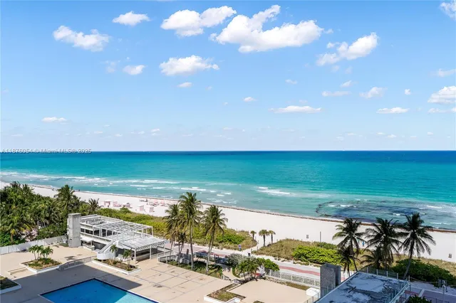 a spacious bedroom with a bed and a lamp
