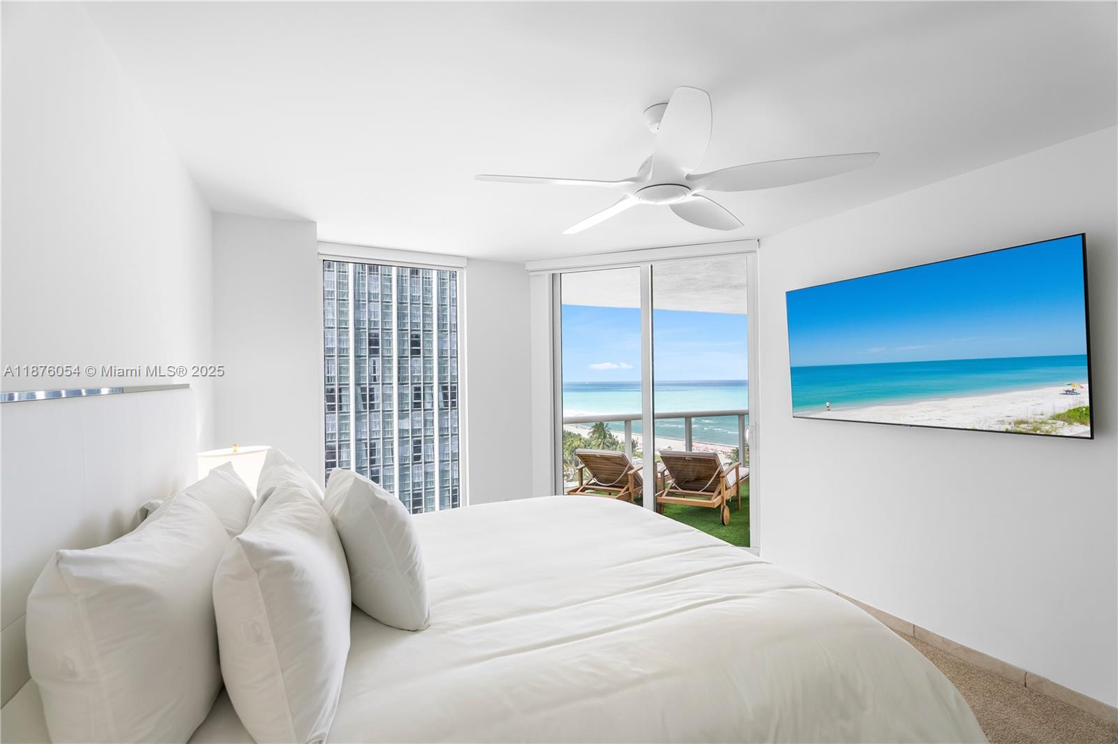 4779 Collins Avenue, Unit 1008 Miami Beach, FL 33140 - Photo 5 of 36 a bedroom with a bed and a large window