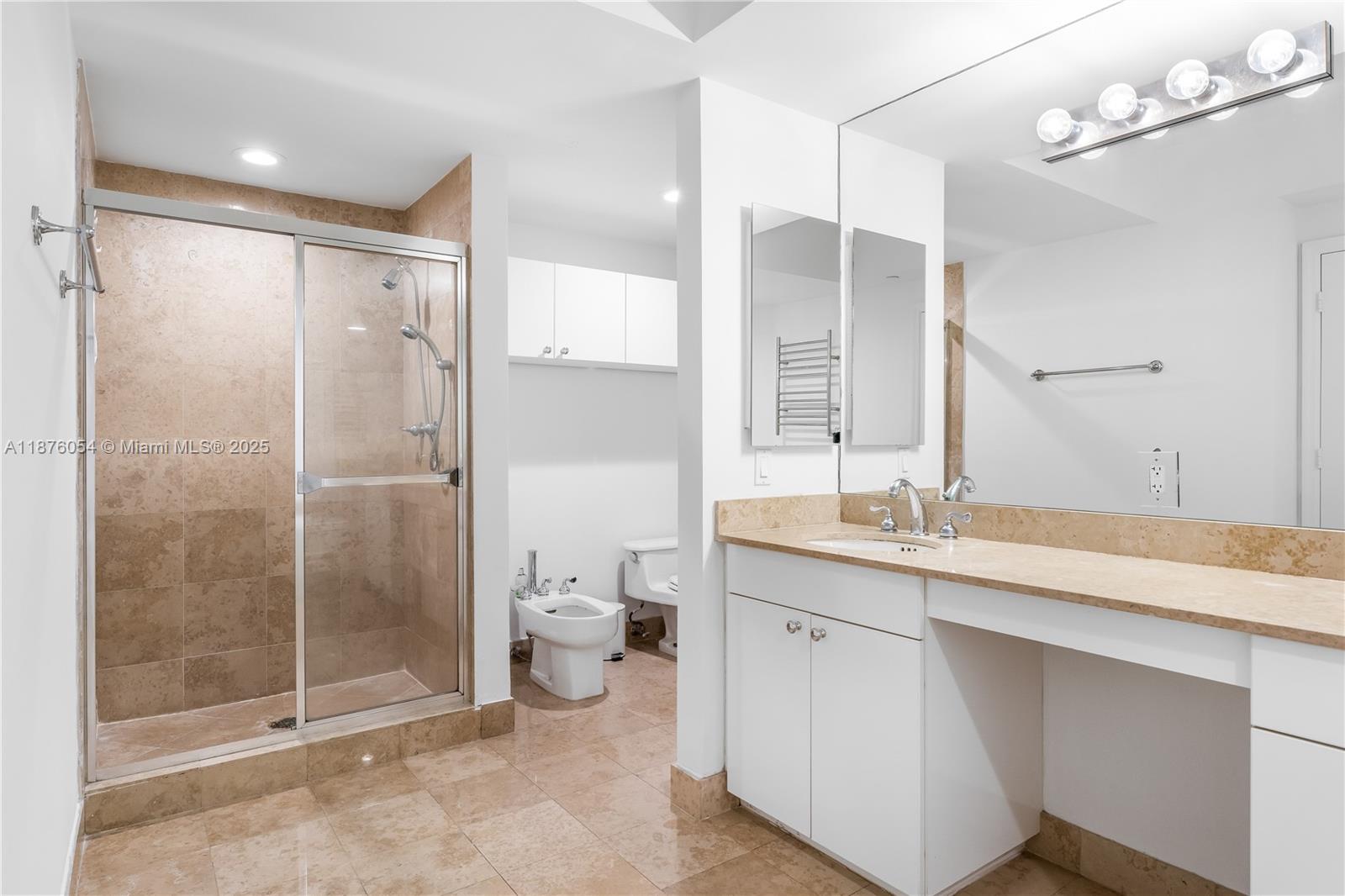 4779 Collins Avenue, Unit 1008 Miami Beach, FL 33140 - Photo 7 of 36 a bathroom with a shower sink and mirror