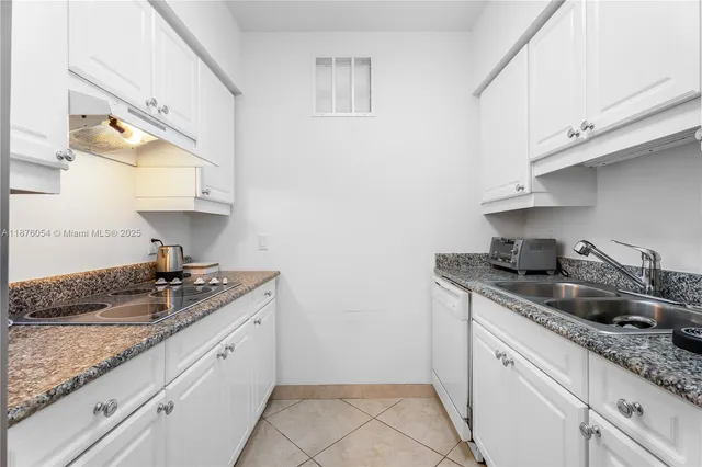 a kitchen with stainless steel appliances granite countertop a sink and a refrigerator