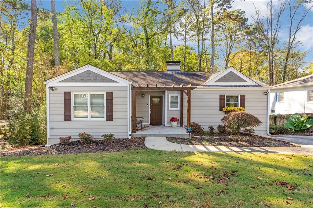 a front view of a house with yard porch and furniture