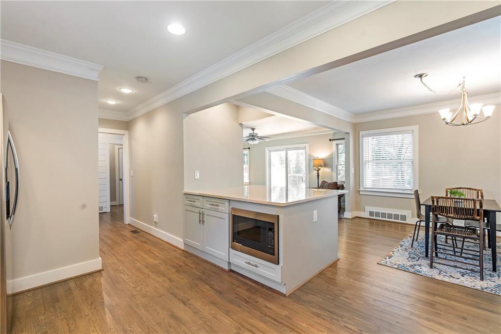 1403 Lavista Road Northeast Atlanta, GA 30324 - Photo 11 of 43 an empty room with wooden floor and fireplace