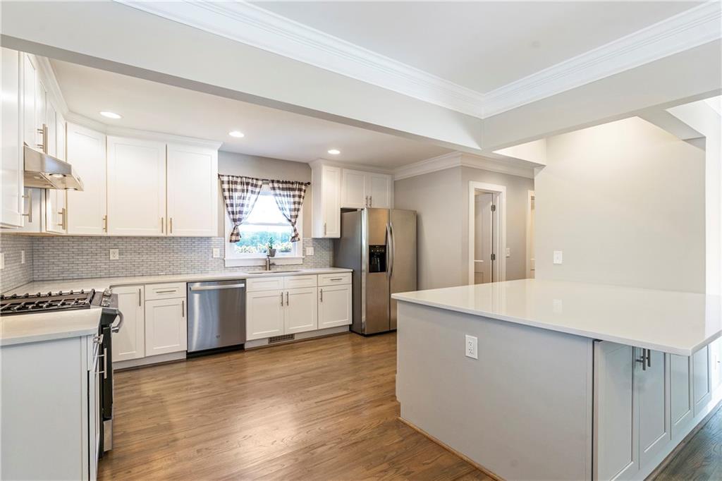 1403 Lavista Road Northeast Atlanta, GA 30324 - Photo 13 of 43 a kitchen with white cabinets and white appliances