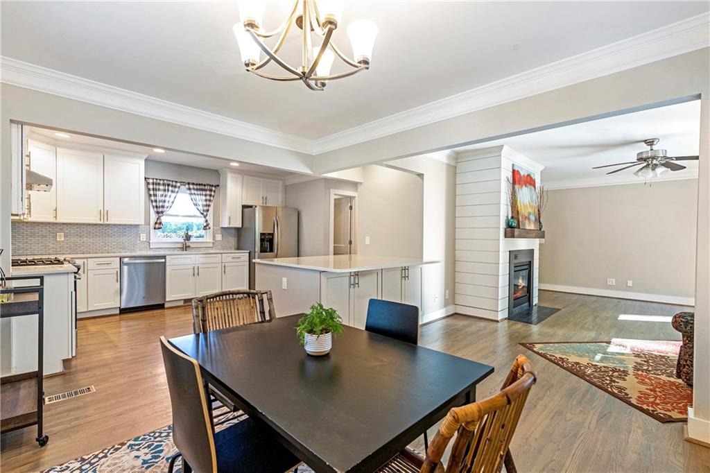 1403 Lavista Road Northeast Atlanta, GA 30324 - Photo 14 of 43 a view of a dining room and livingroom with furniture wooden floor and a chandelier