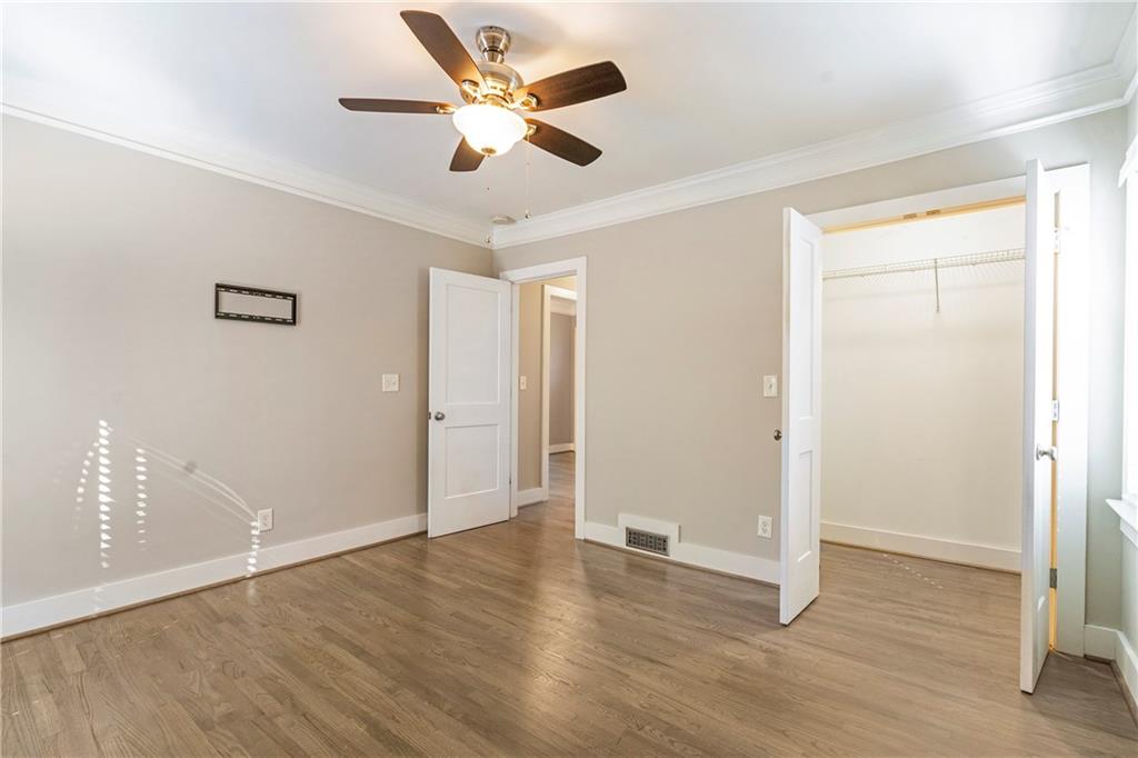 1403 Lavista Road Northeast Atlanta, GA 30324 - Photo 19 of 43 an empty room with wooden floor and a ceiling fan