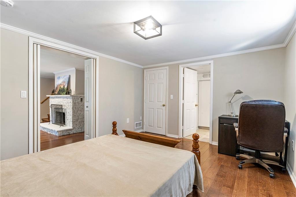 1403 Lavista Road Northeast Atlanta, GA 30324 - Photo 27 of 43 a bedroom with a bed and chair