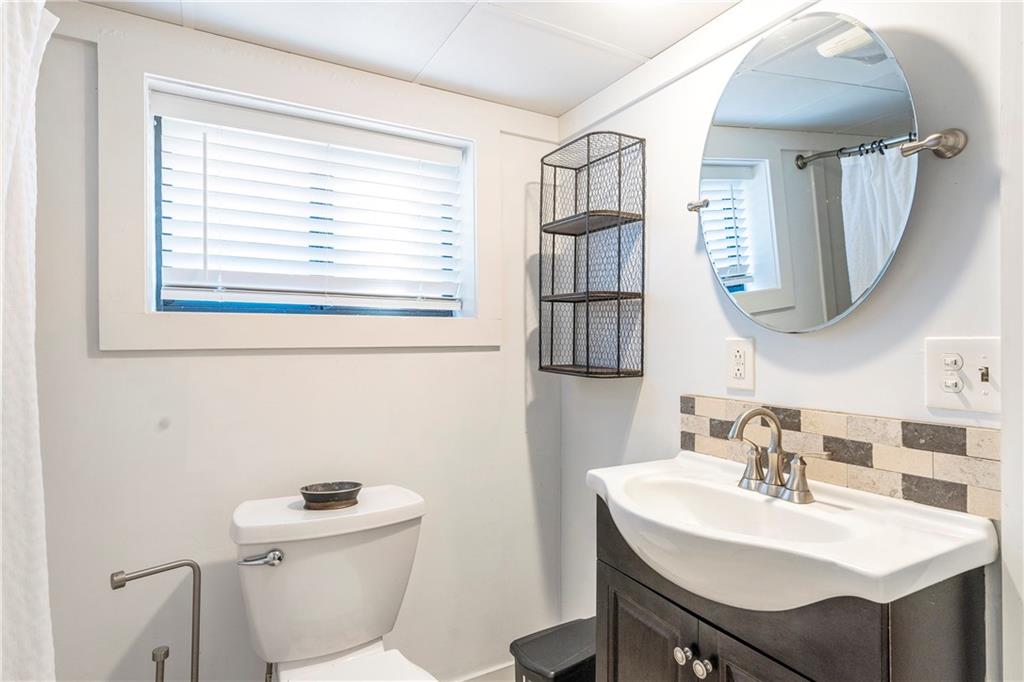 1403 Lavista Road Northeast Atlanta, GA 30324 - Photo 29 of 43 a bathroom with a toilet a sink and a mirror