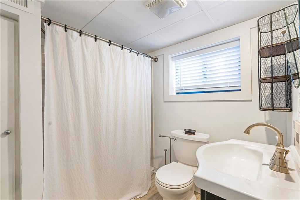 1403 Lavista Road Northeast Atlanta, GA 30324 - Photo 30 of 43 a bathroom with a toilet a sink and a window
