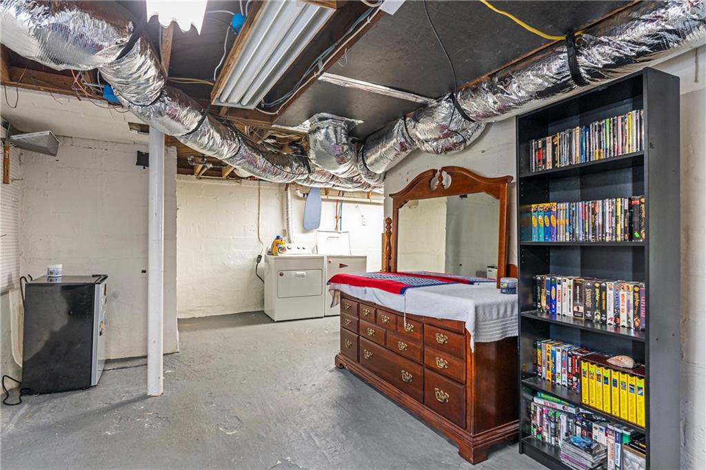 1403 Lavista Road Northeast Atlanta, GA 30324 - Photo 31 of 43 a living room with furniture and a book shelf