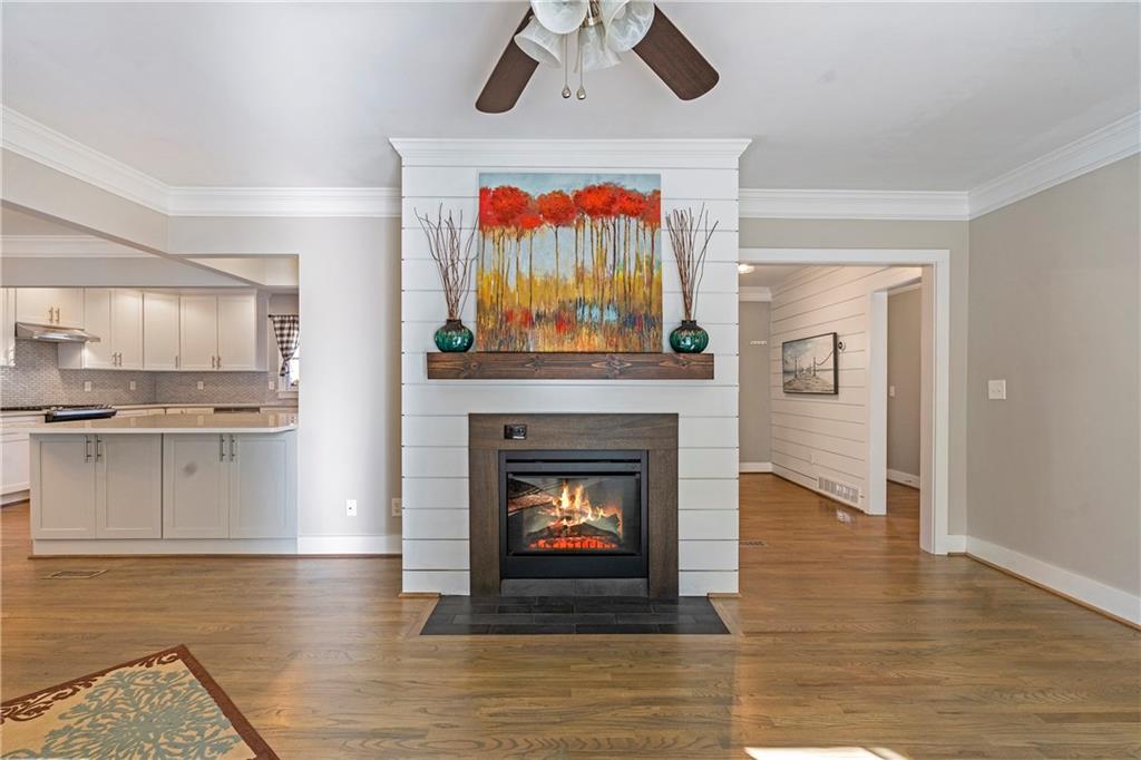 1403 Lavista Road Northeast Atlanta, GA 30324 - Photo 7 of 43 a living room with stainless steel appliances a fireplace and a fireplace