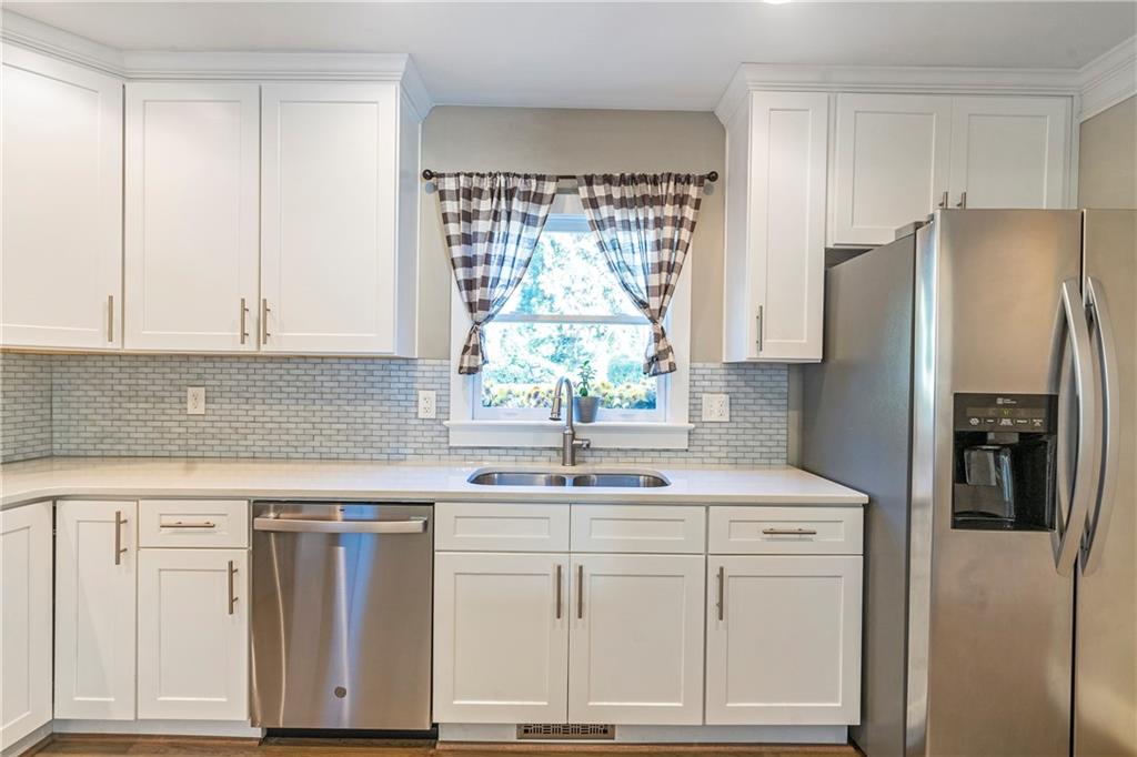1403 Lavista Road Northeast Atlanta, GA 30324 - Photo 10 of 43 a kitchen with white cabinets and window