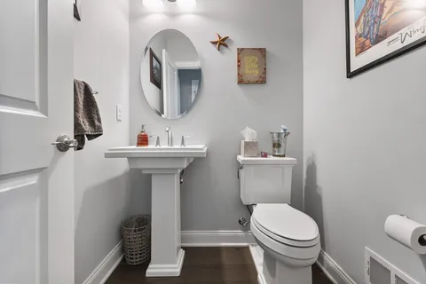 a bathroom with a sink toilet and mirror