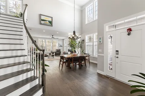 a dining room with furniture entryway and wooden floor